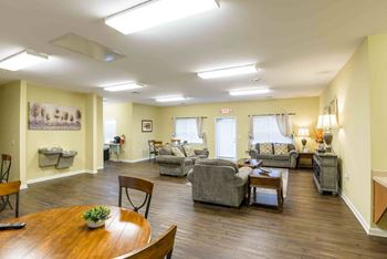 A living room with a wooden table and chairs. at Robinson Park Apartments, Harrisonburg, VA, 22801